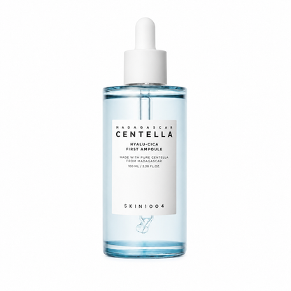A clear dropper bottle of SKIN1004 Madagascar Centella Hyalu-Cica First Ampoule containing a light blue liquid, featuring a white minimalist label and white dropper cap.