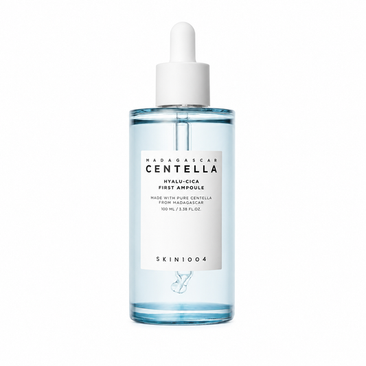 A clear dropper bottle of SKIN1004 Madagascar Centella Hyalu-Cica First Ampoule containing a light blue liquid, featuring a white minimalist label and white dropper cap.