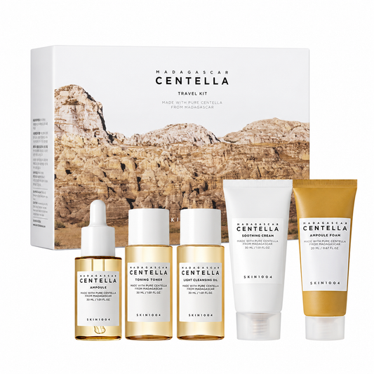 SKIN1004 Madagascar Centella Travel Kit containing five miniature skincare products lined up in front of their white and brown landscape-themed packaging box.